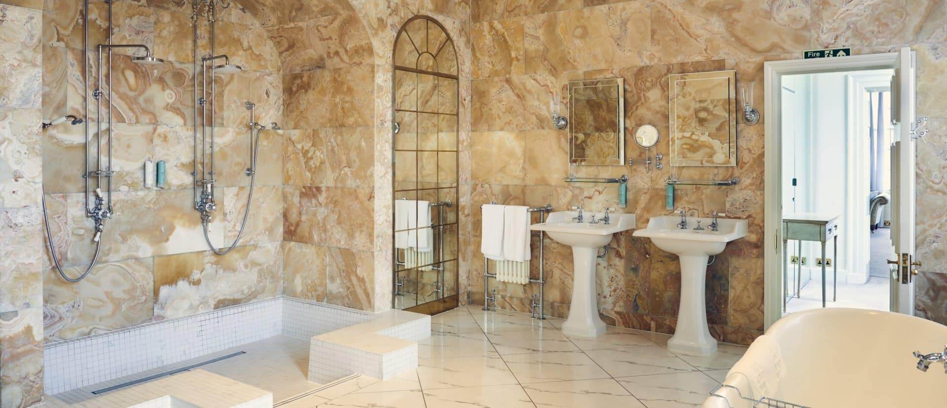 Large bathroom perfect for a wedding containing two showers and two sinks