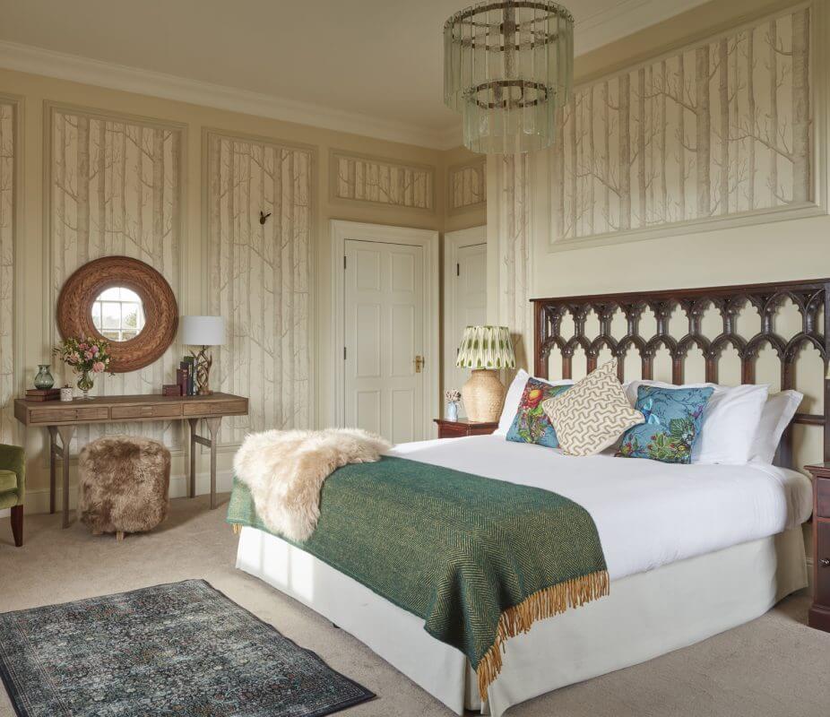 The Skye Suite wedding guest bedroom showing a large bed and mirror
