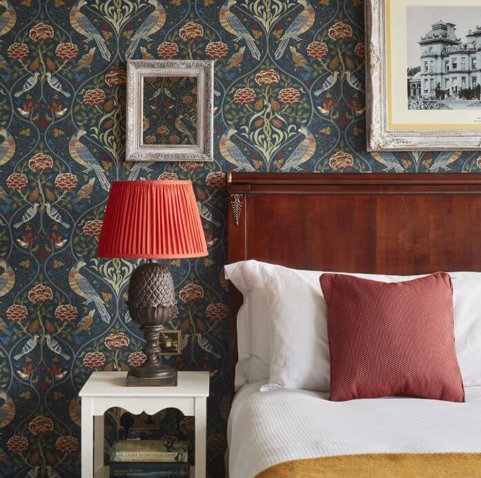 Guest accommodation of Hedsor wedding venue showing a bedside table and bed