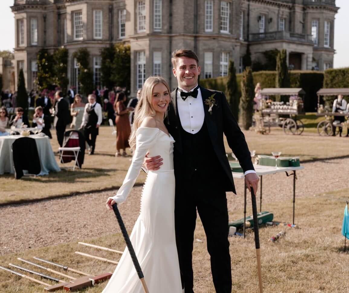 Bride and Groom playing croquet in the English country gardens at Hedsor House
